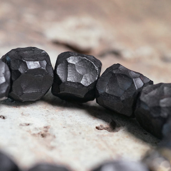 Bracelet Mala en bois d'ébène et cuivre avec Buddha Stones et pompon de paix