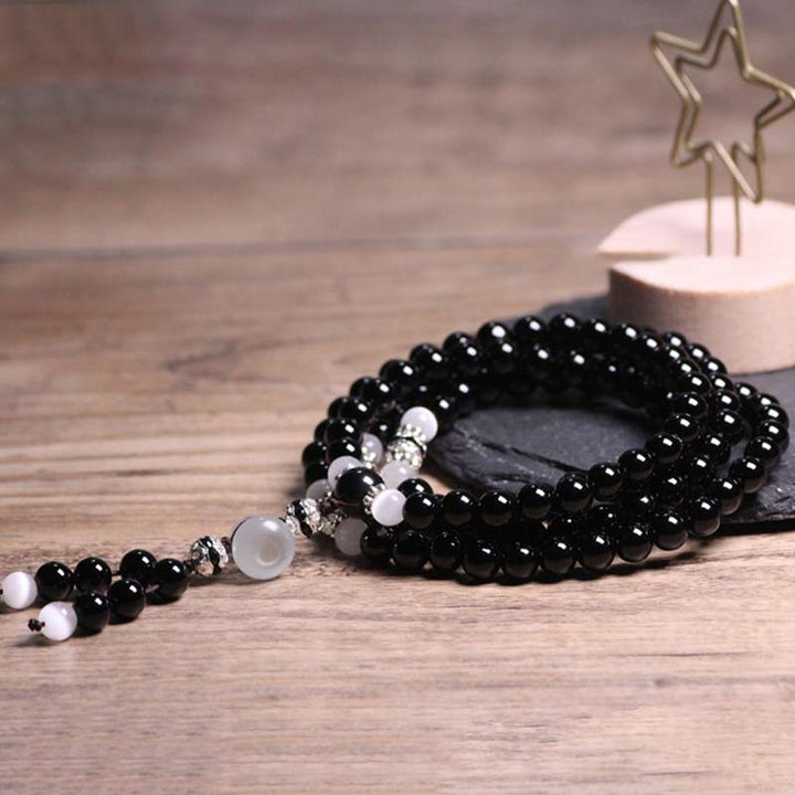 Bracelet de méditation en perles de cristal blanc et onyx noir Buddha Stones
