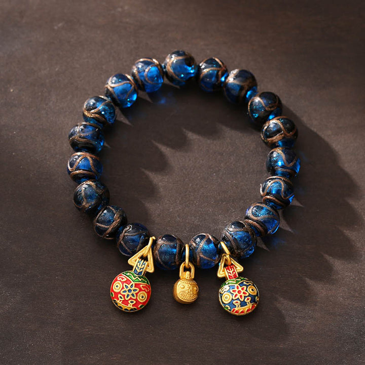 Bracelet porte-bonheur en perles de verre Liuli bleues avec Buddha Stones et bête avaleuse en or