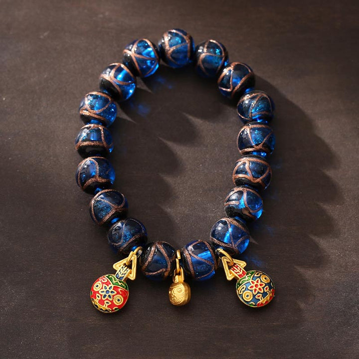 Bracelet porte-bonheur en perles de verre Liuli bleues avec Buddha Stones et bête avaleuse en or