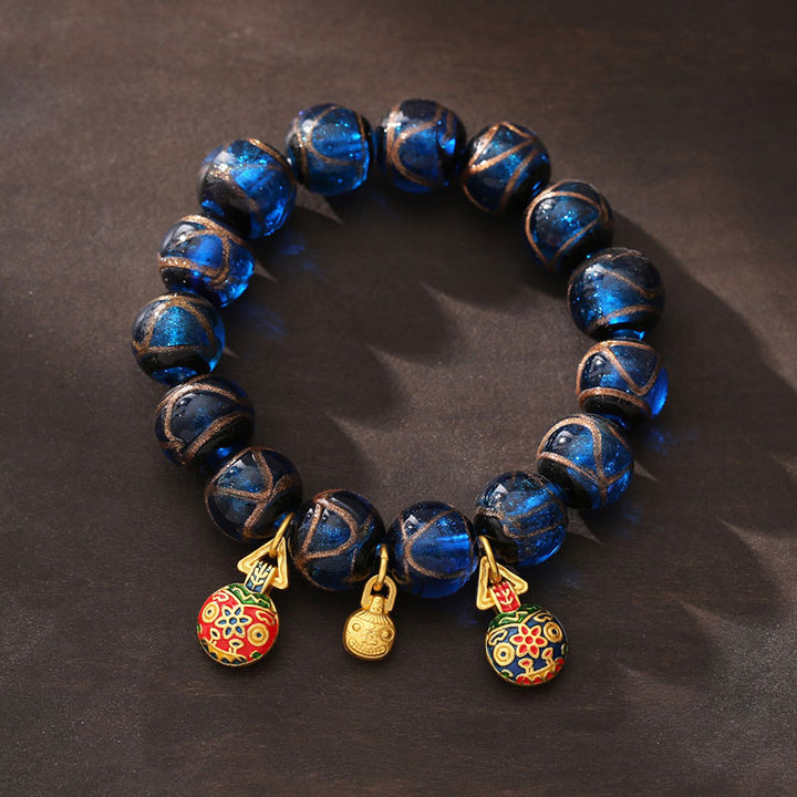 Bracelet porte-bonheur en perles de verre Liuli bleues avec Buddha Stones et bête avaleuse en or