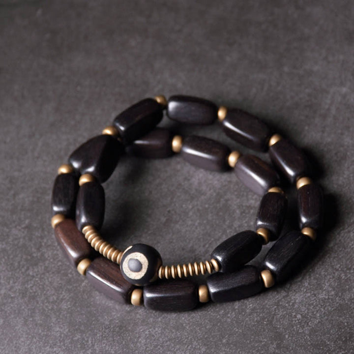 Bracelet double tour en cuivre avec perles dzi en bois d'ébène et Buddha Stones du Tibet