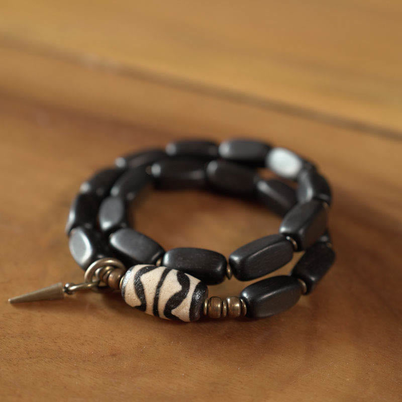 Bracelet double tour en cuivre avec perles dzi en bois d'ébène et Buddha Stones du Tibet