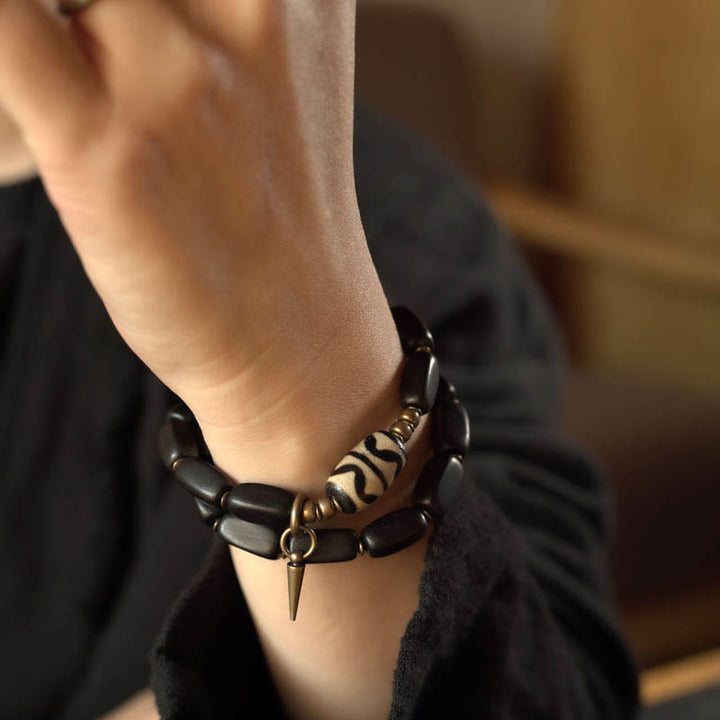 Bracelet double tour en cuivre avec perles dzi en bois d'ébène et Buddha Stones du Tibet