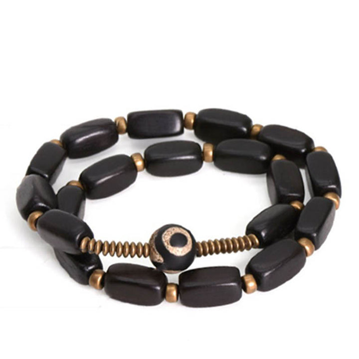 Bracelet double tour en cuivre avec perles dzi en bois d'ébène et Buddha Stones du Tibet