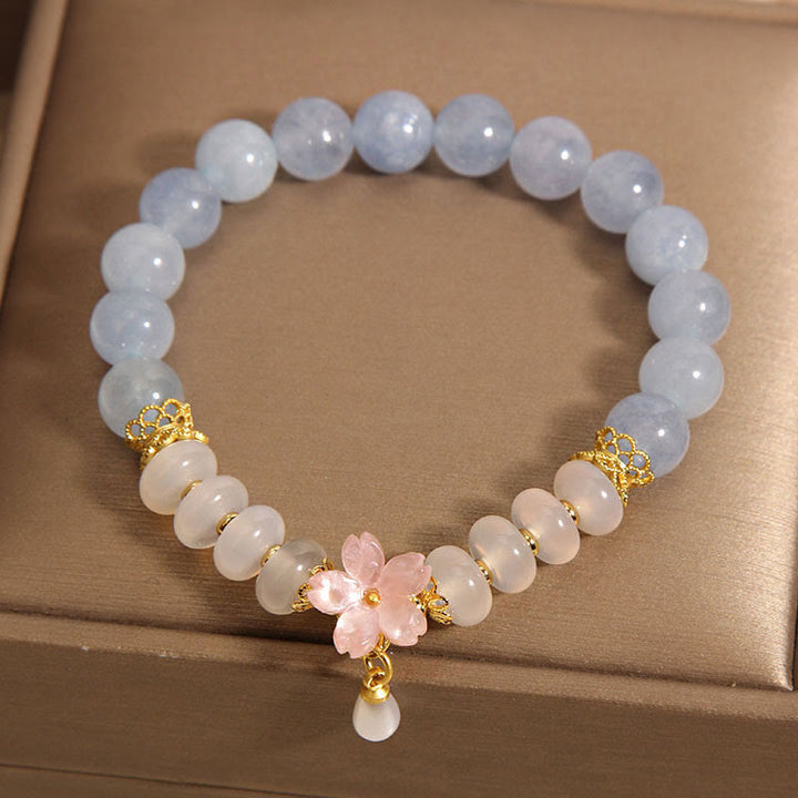 Bracelet de guérison en forme de fleur avec perles d'agate blanche et aigue-marine en Buddha Stones