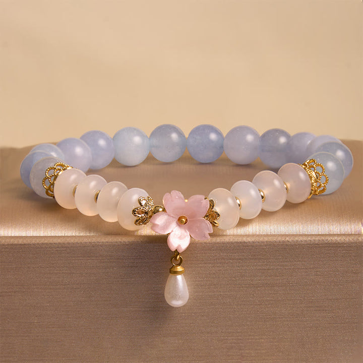 Bracelet de guérison en forme de fleur avec perles d'agate blanche et aigue-marine en Buddha Stones