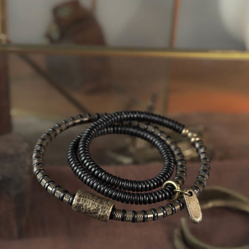 Bracelet multicouche en cuivre et perles en bois d'ébène tibétain avec Buddha Stones