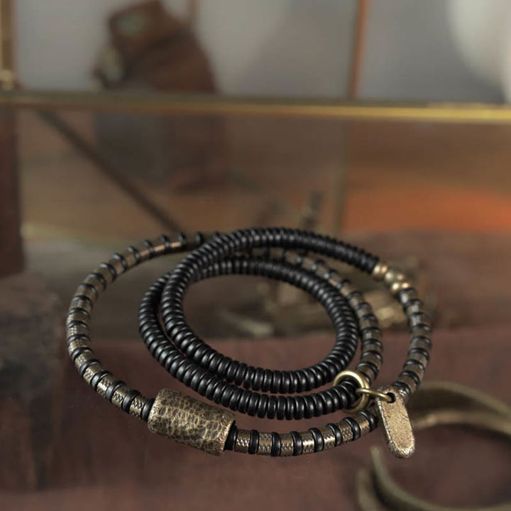 Bracelet multicouche en cuivre et perles en bois d'ébène tibétain avec Buddha Stones