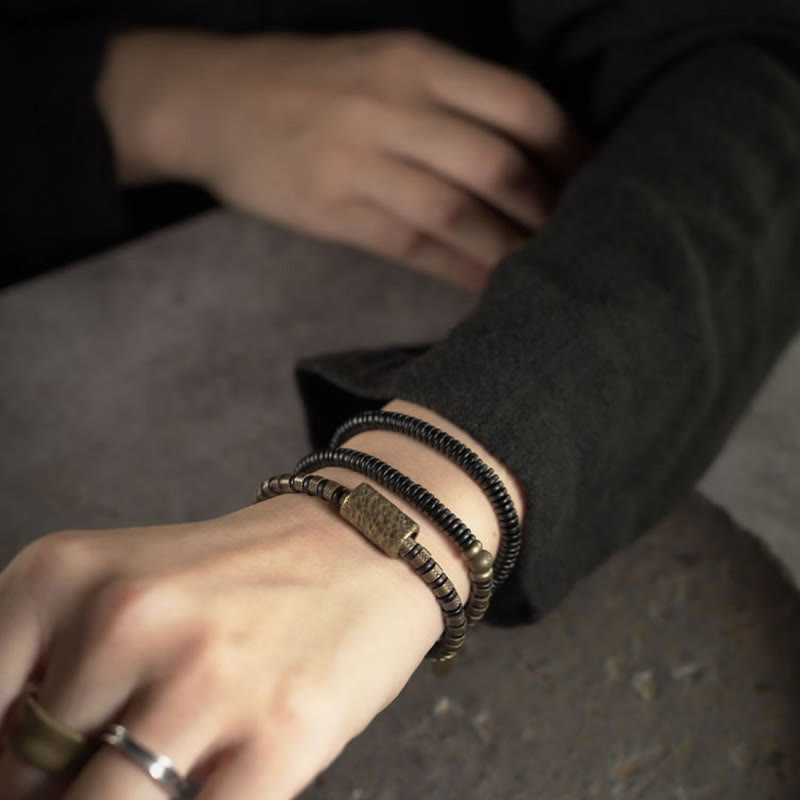 Bracelet multicouche en cuivre et perles en bois d'ébène tibétain avec Buddha Stones