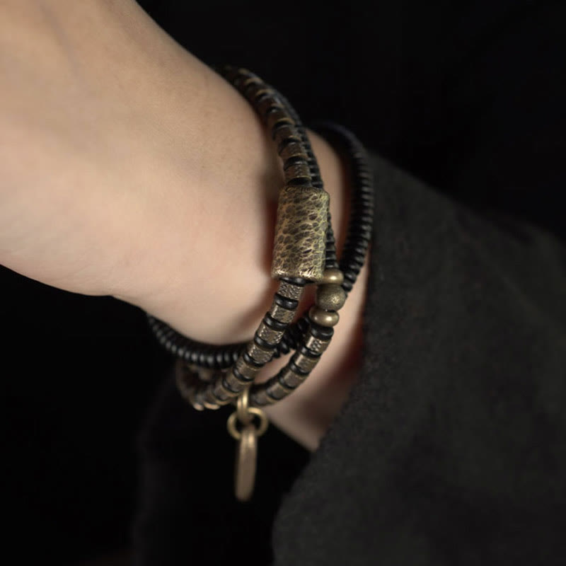 Bracelet multicouche en cuivre et perles en bois d'ébène tibétain avec Buddha Stones