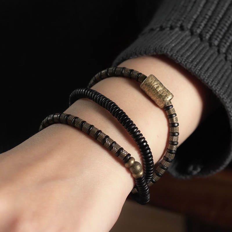 Bracelet multicouche en cuivre et perles en bois d'ébène tibétain avec Buddha Stones