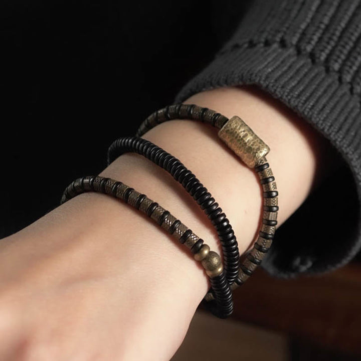 Bracelet multicouche en cuivre et perles en bois d'ébène tibétain avec Buddha Stones