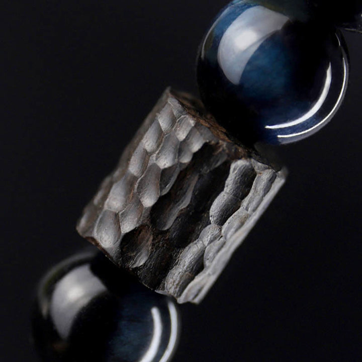 Bracelet calme en perles de bois d'ébène et œil de tigre avec Buddha Stones