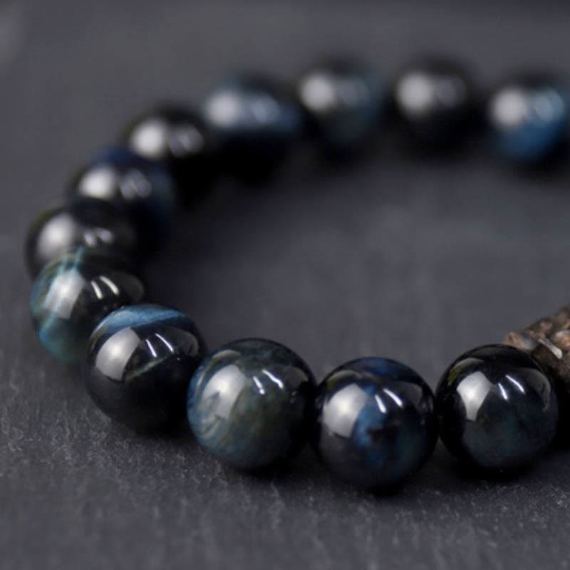 Bracelet calme en perles de bois d'ébène et œil de tigre avec Buddha Stones