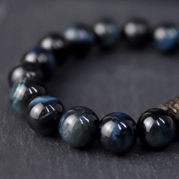 Bracelet calme en perles de bois d'ébène et œil de tigre avec Buddha Stones