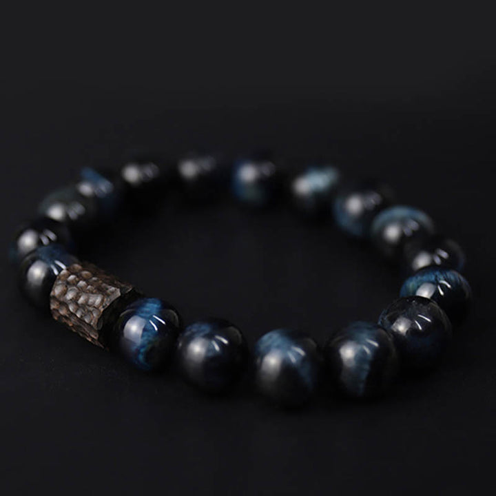 Bracelet calme en perles de bois d'ébène et œil de tigre avec Buddha Stones