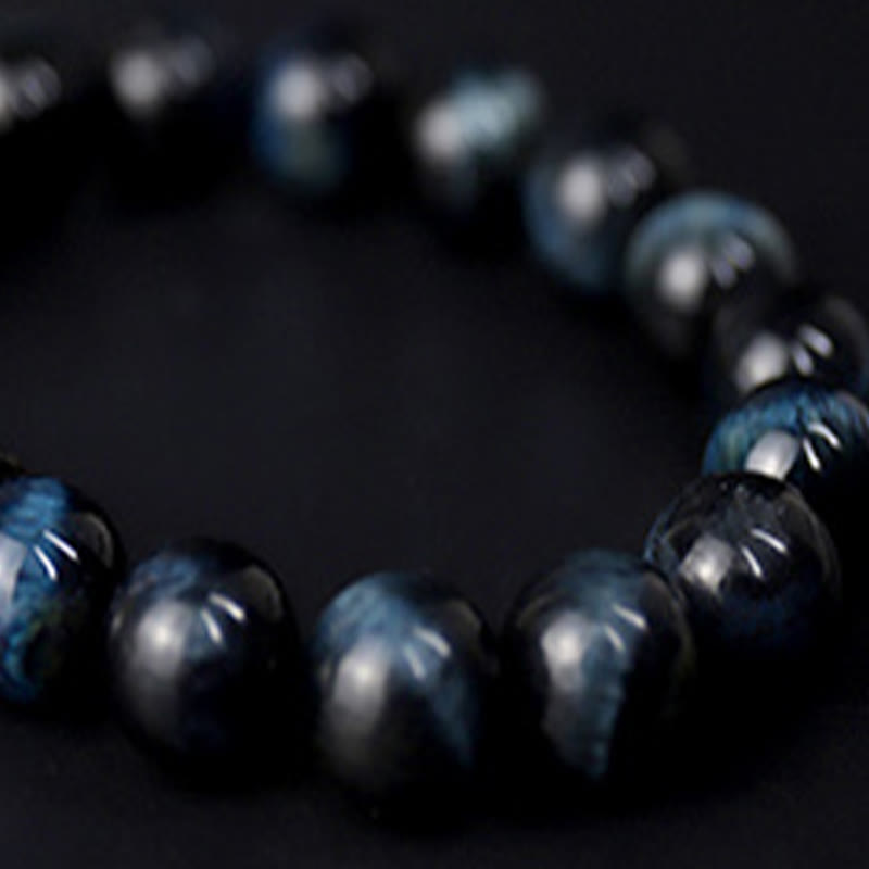Bracelet calme en perles de bois d'ébène et œil de tigre avec Buddha Stones