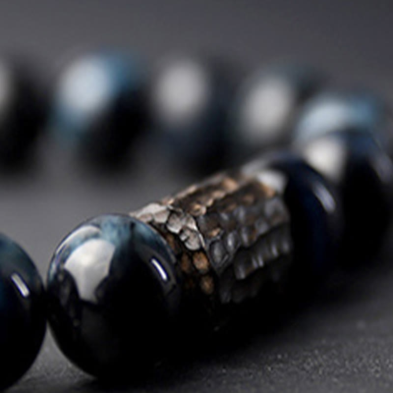 Bracelet calme en perles de bois d'ébène et œil de tigre avec Buddha Stones