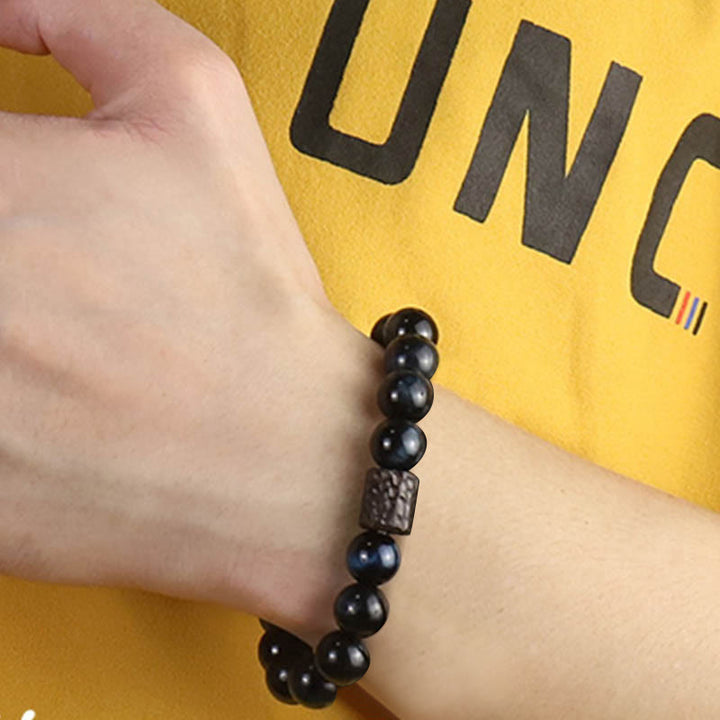 Bracelet calme en perles de bois d'ébène et œil de tigre avec Buddha Stones