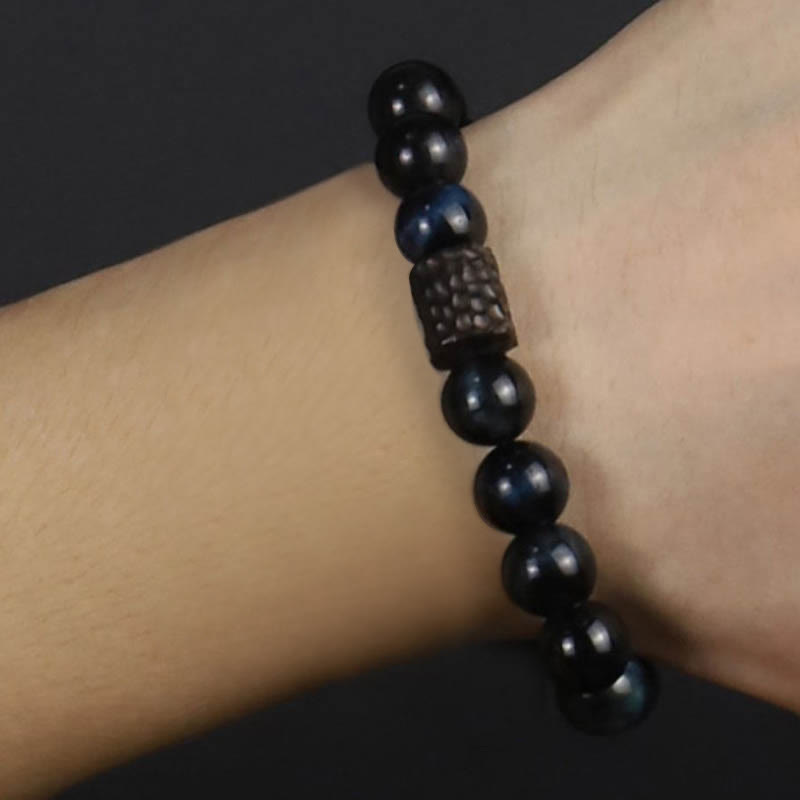 Bracelet calme en perles de bois d'ébène et œil de tigre avec Buddha Stones