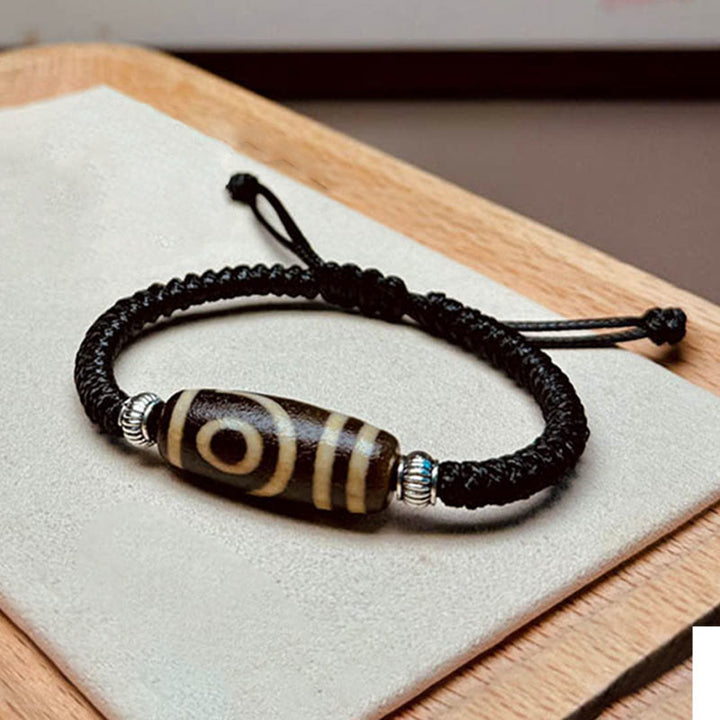 Bracelet en corde de protection de richesse Buddha Stones tibétaines à neuf yeux et à trois yeux