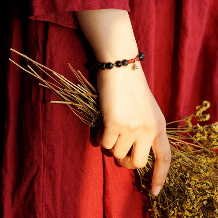 Bracelet de force et d'accomplissement en obsidienne noire naturelle et cinabre avec breloque lotus et Buddha Stones