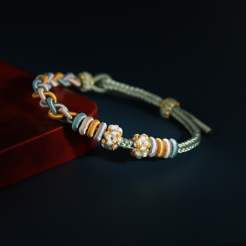 Bracelet de connexion en fleur de pêcher avec quatre Buddha Stones