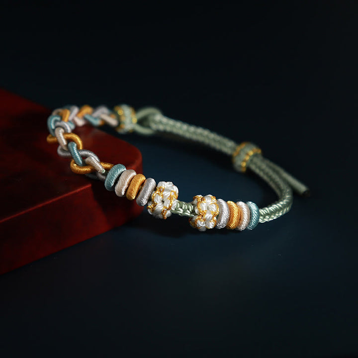 Bracelet de connexion en fleur de pêcher avec quatre Buddha Stones