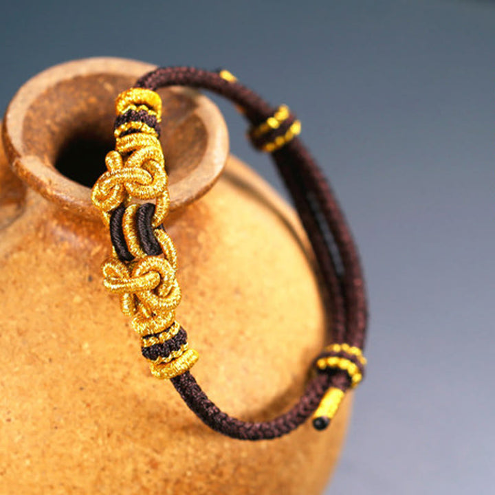 Bracelet de force en corde rouge avec nœud de selle et Buddha Stones