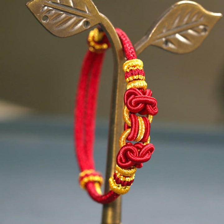 Bracelet de force en corde rouge avec nœud de selle et Buddha Stones