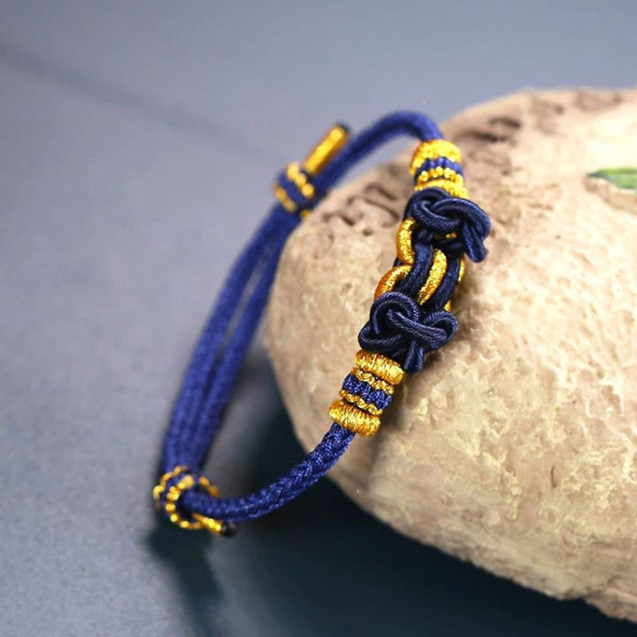 Bracelet de force en corde rouge avec nœud de selle et Buddha Stones