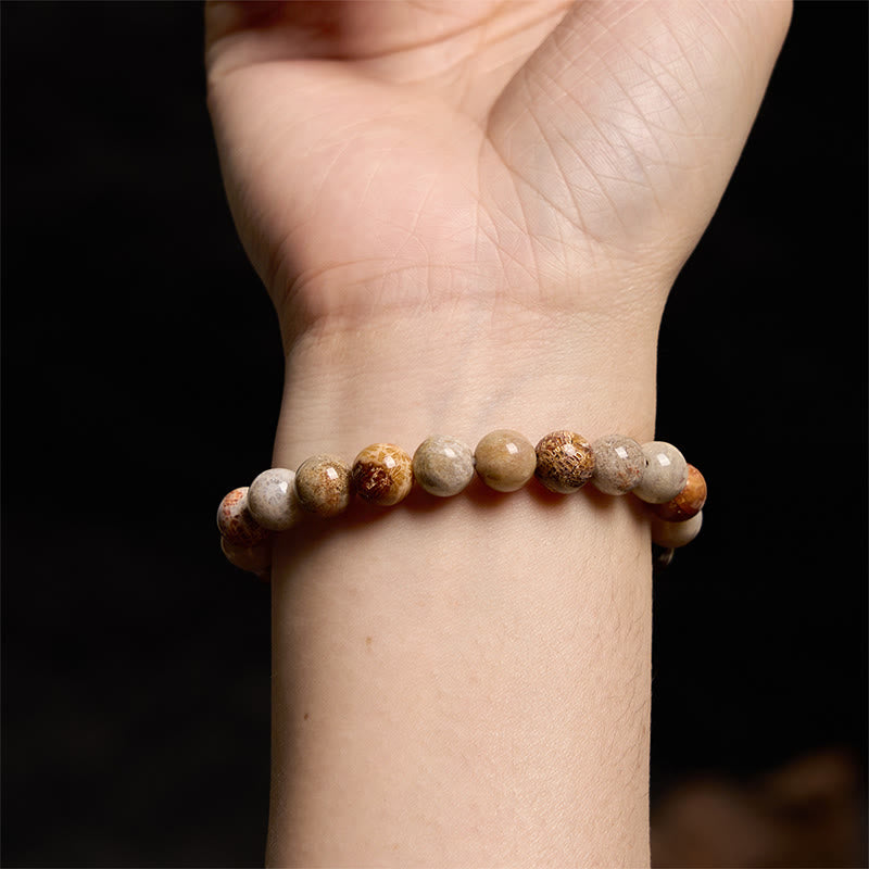 Bracelet de compassion en corail fossile Buddha Stones