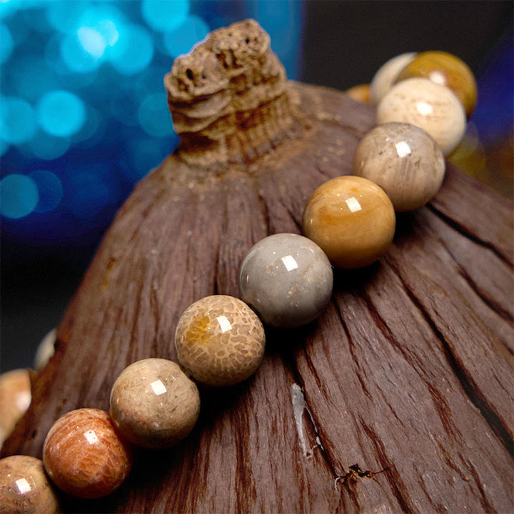 Bracelet de compassion en corail fossile Buddha Stones