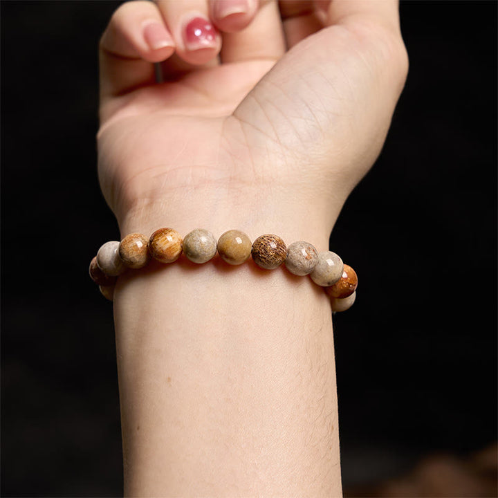 Bracelet de compassion en corail fossile Buddha Stones
