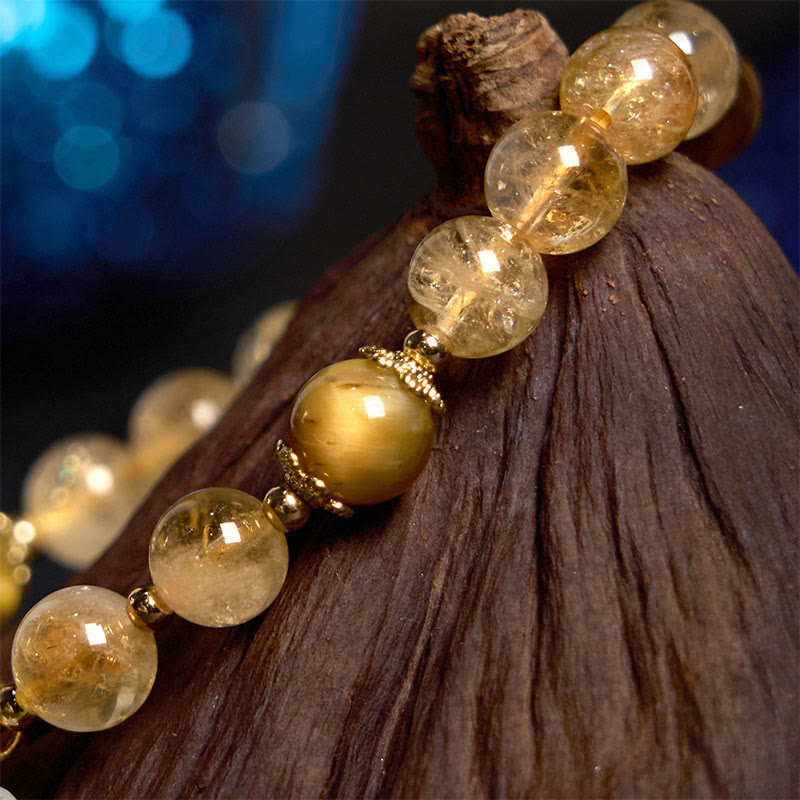 Bracelet de générosité avec breloque fleur œil de tigre et citrine en Buddha Stones
