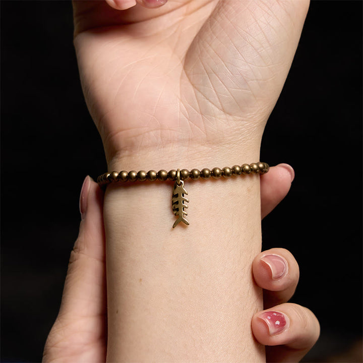 Bracelet de guérison en arête de poisson en cuivre et Buddha Stones