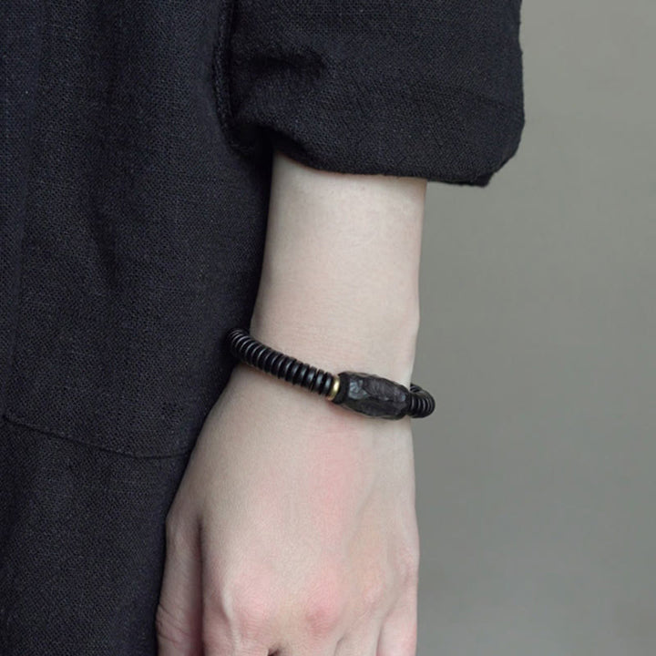 Bracelet d'équilibre troué en bois d'ébène et cuivre et laiton avec Buddha Stones