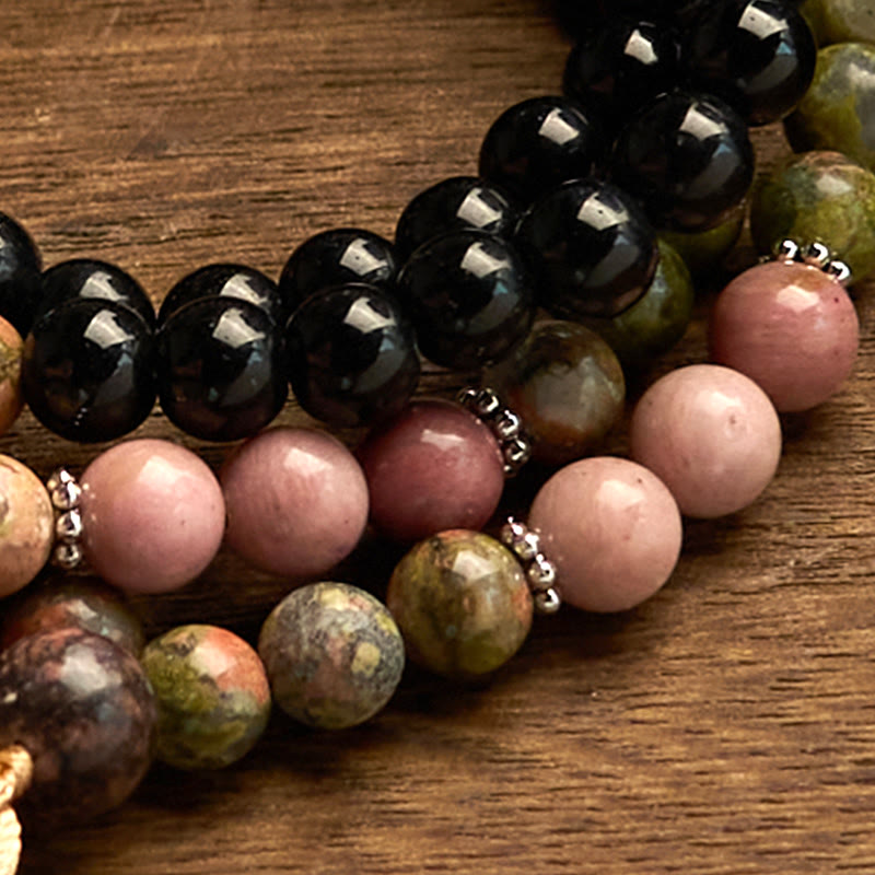 Bracelet de guérison à pompon kaki en jaspe noir et rhodonite avec 108 perles de Mala Buddha Stones