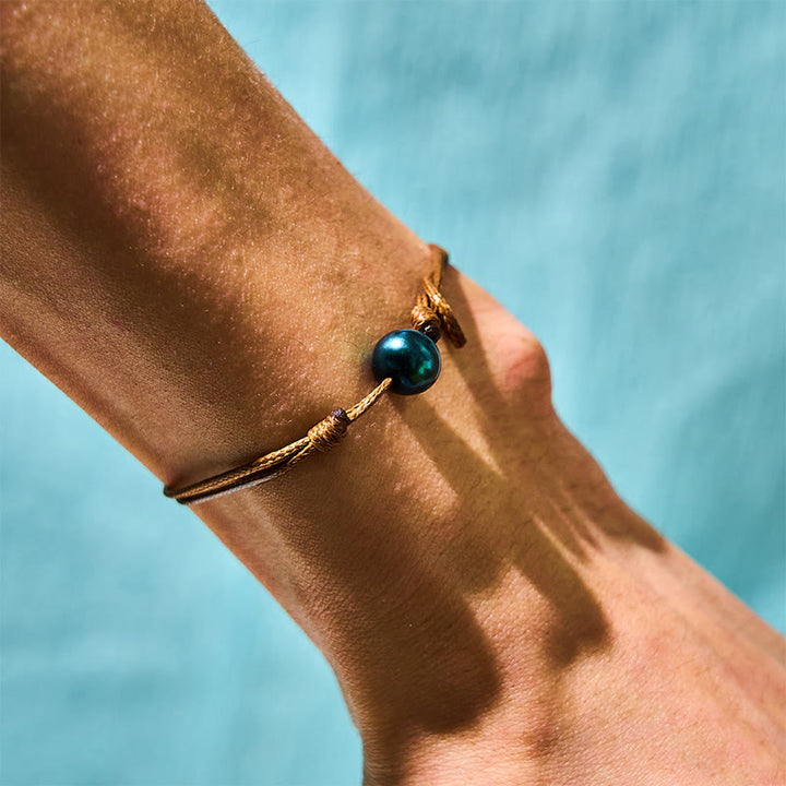 Bracelet de guérison en corde de cire avec perles noires naturelles de Tahiti et Buddha Stones