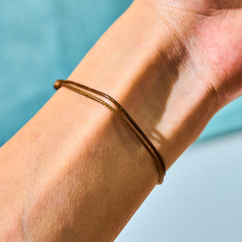 Bracelet de guérison en corde de cire avec perles noires naturelles de Tahiti et Buddha Stones