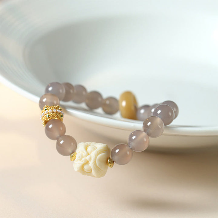 Bracelet de confiance en Buddha Stones, ambre, agate grise, ivoire et fruit