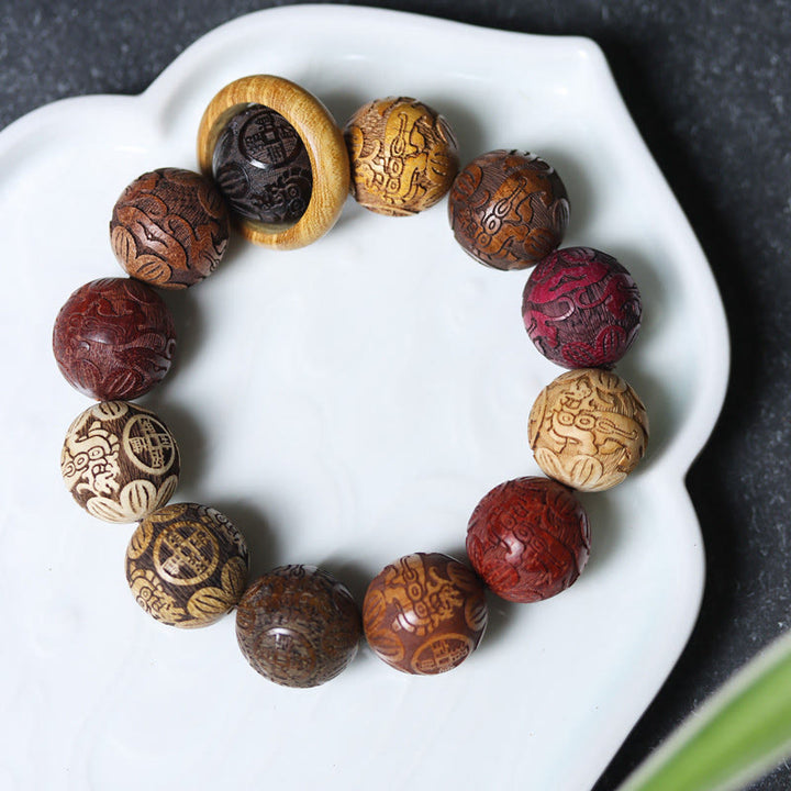 Bracelet de guérison en bois de santal sculpté avec Buddha Stones et symbole du zodiaque chinois, dragon, phénix, caractère Fu