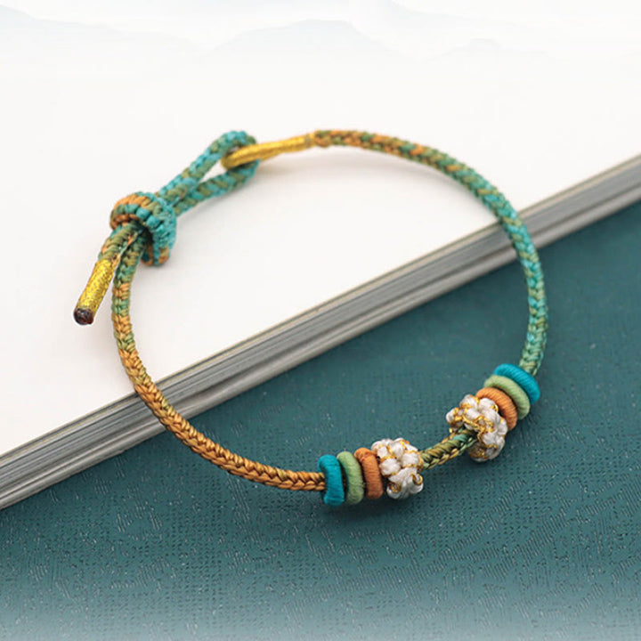 Bracelet tressé fait main en corde porte-bonheur avec nœud de paix à huit fils et nœud de fleur de pêcher en Buddha Stones - image 2