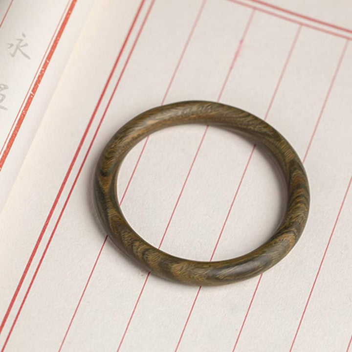 Bracelet de protection tibétain en petites feuilles de bois de santal rouge et ébène avec Buddha Stones