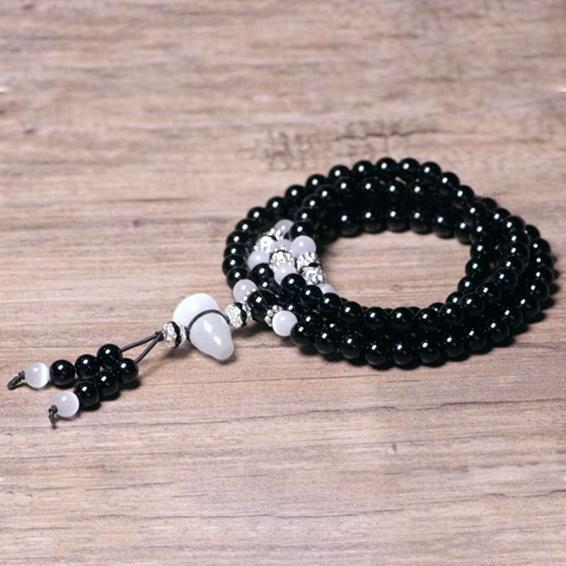 Bracelet de méditation en perles de cristal blanc et onyx noir Buddha Stones