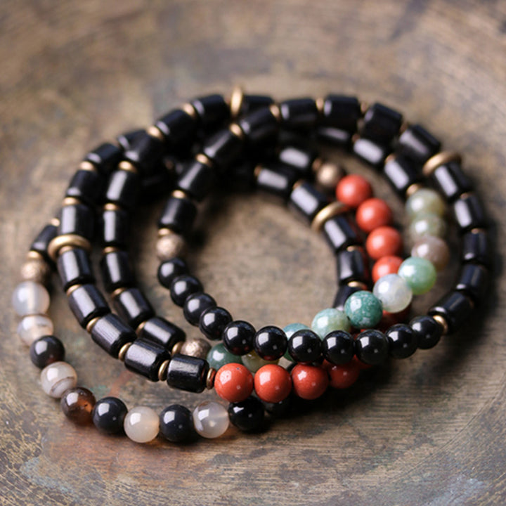 Bracelet couple paix Buddha Stones bois d'ébène jaspe rouge mousse agate cristal cuivre