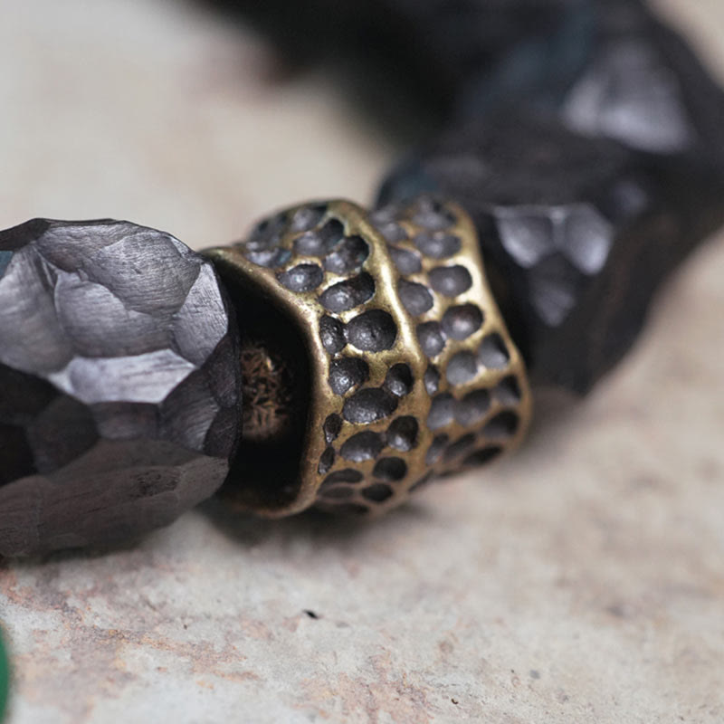 Bracelet Mala en bois d'ébène et cuivre avec Buddha Stones et pompon de paix