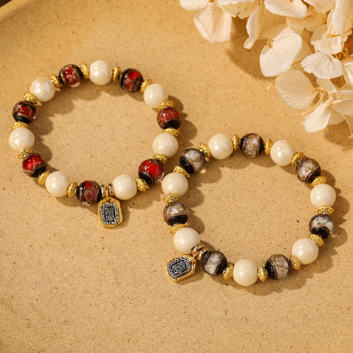 Bracelet de protection en perles de porcelaine en cendres et en verre Liuli avec breloque en Buddha Stones et déesse de la richesse tibétaine Zakiram