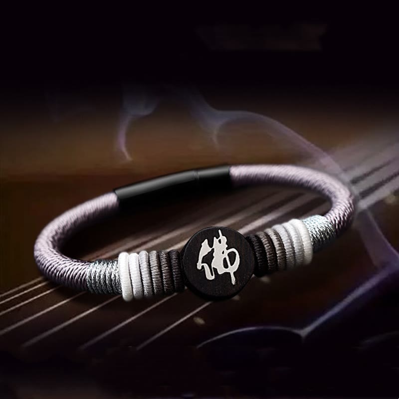 Bracelet en corde fait main en ébène avec personnage de Bouddha de Buddha Stones